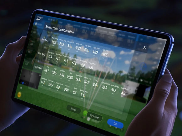Person holding a tablet displaying a chart with golf statistics 