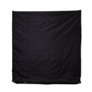 A large, wrinkled black fabric sheet hangs vertically against a plain background.