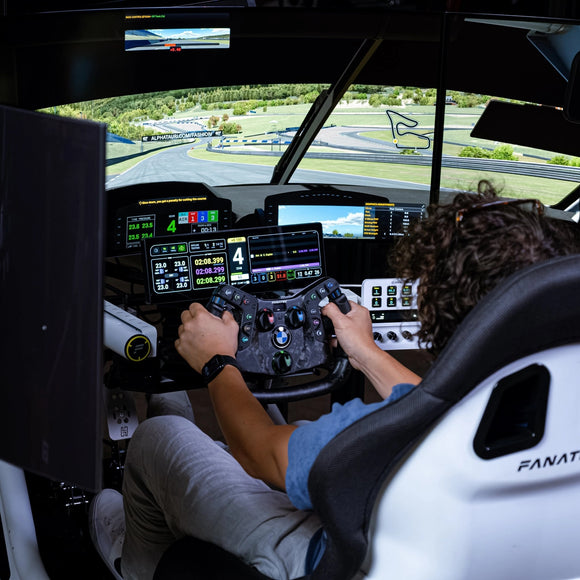 Driver racing in the Turnkey Racing Sims Formula Motion simulator, wide view
