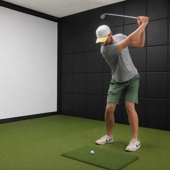 Golfer swinging in a simulator room lined with ROS Signature Golf Simulator Wall Padding