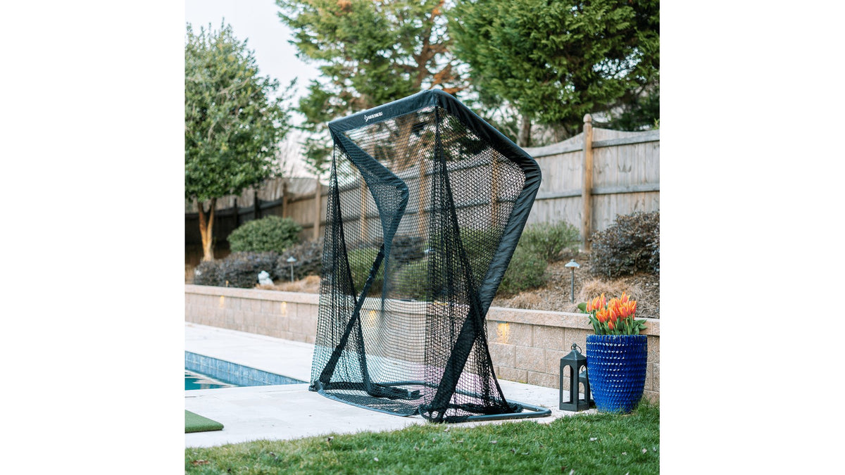 SwingNet Pro XL golf net set up outdoors beside a pool