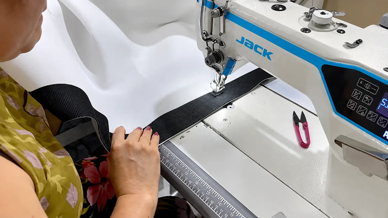 Closeup of a person sewing the finishing details on a TruSim impact screen