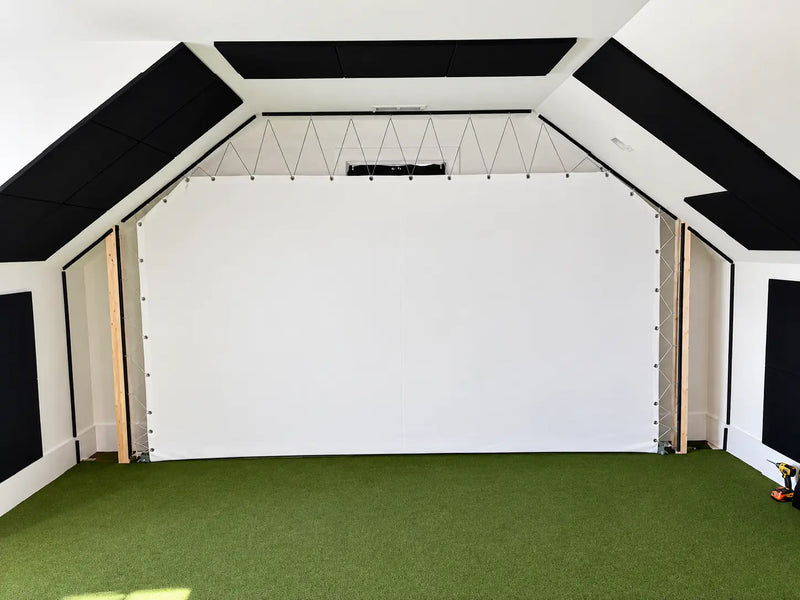 A TruSim impact screen in a golf simulator setup featuring a slanted ceiling
